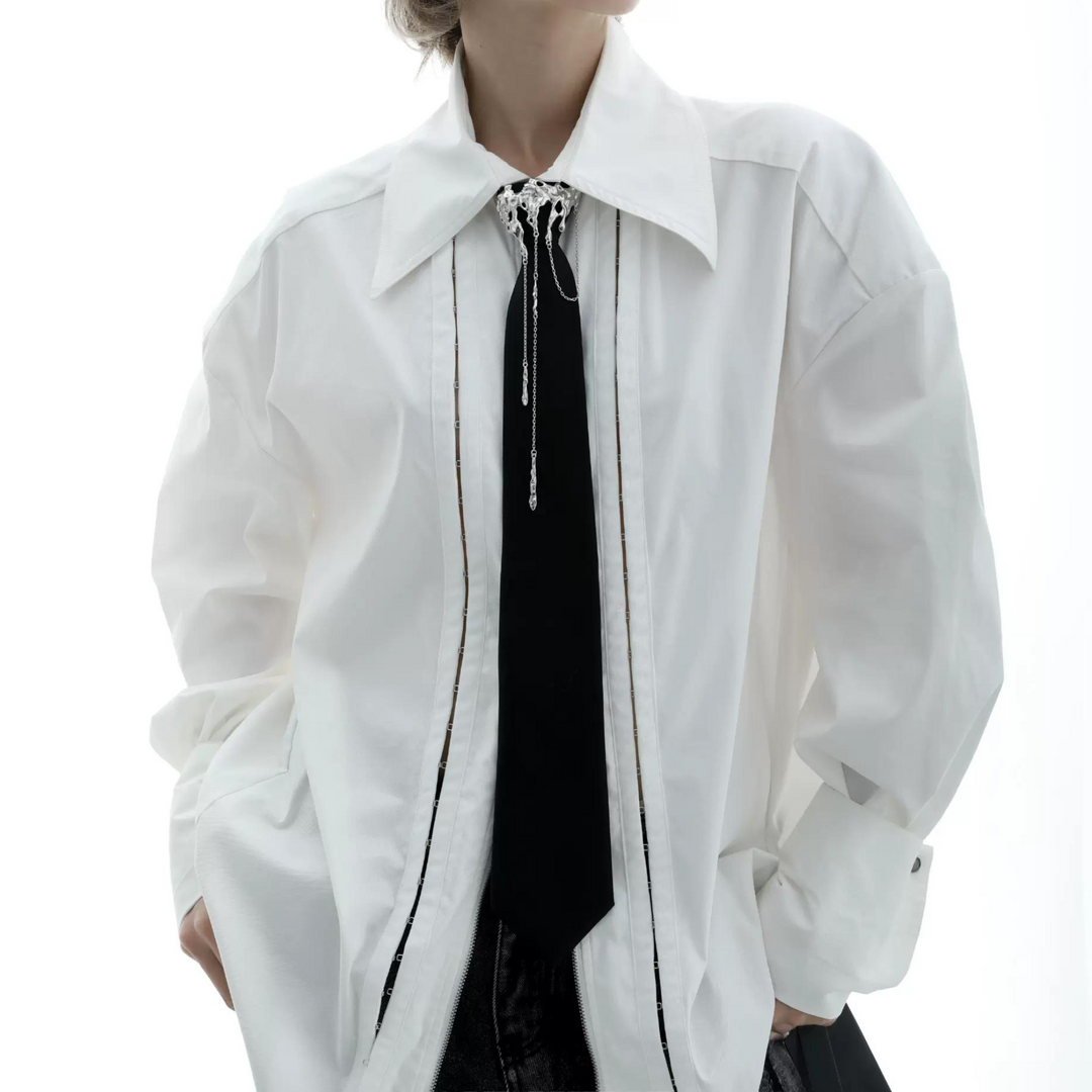 a woman wearing a white jacket and tie