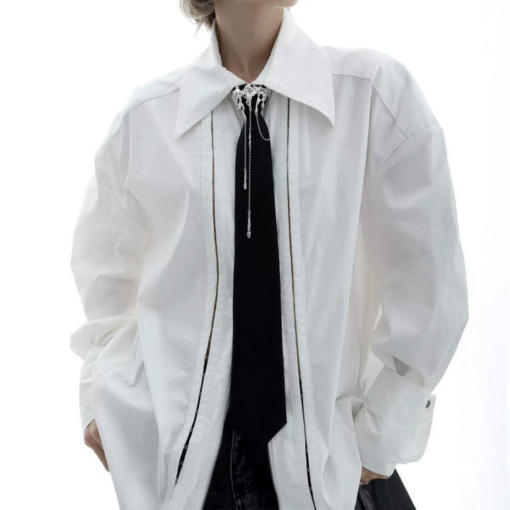 a woman wearing a white jacket and tie