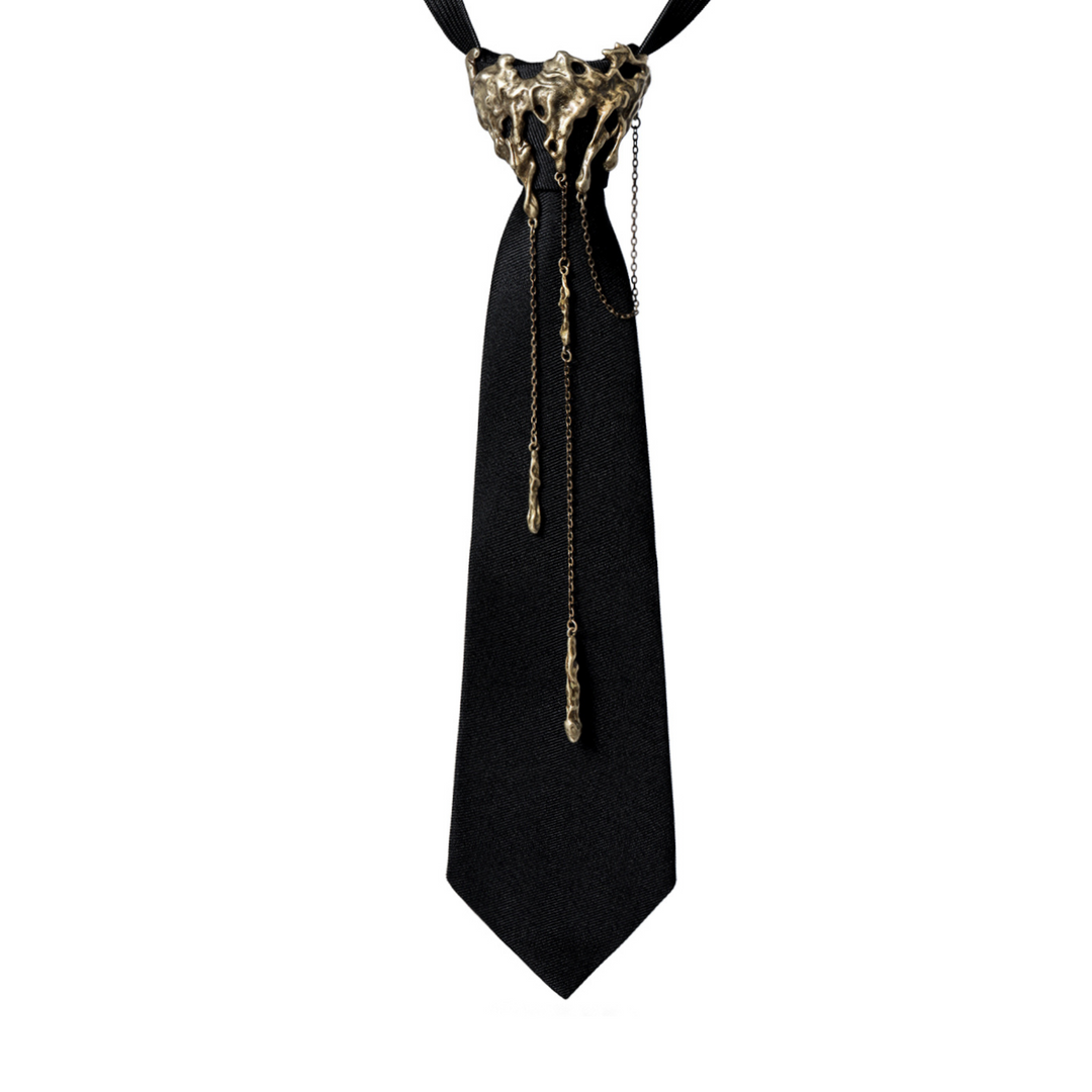 a black tie with a gold chain on it