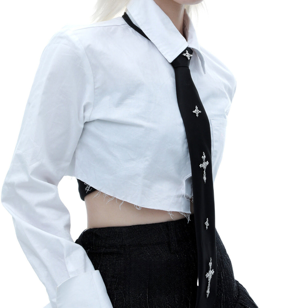 a woman wearing a white shirt and black tie