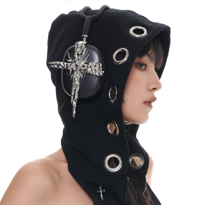 a woman wearing a hood with a cross on it