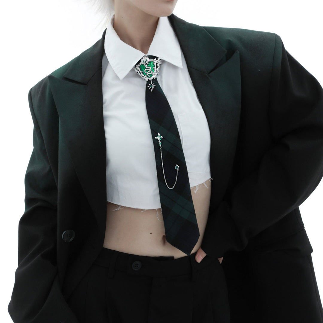 a woman wearing a suit and tie with a cross on it