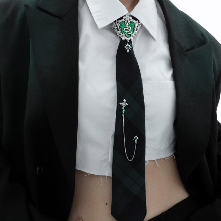 a woman wearing a black tie with a green cross on it