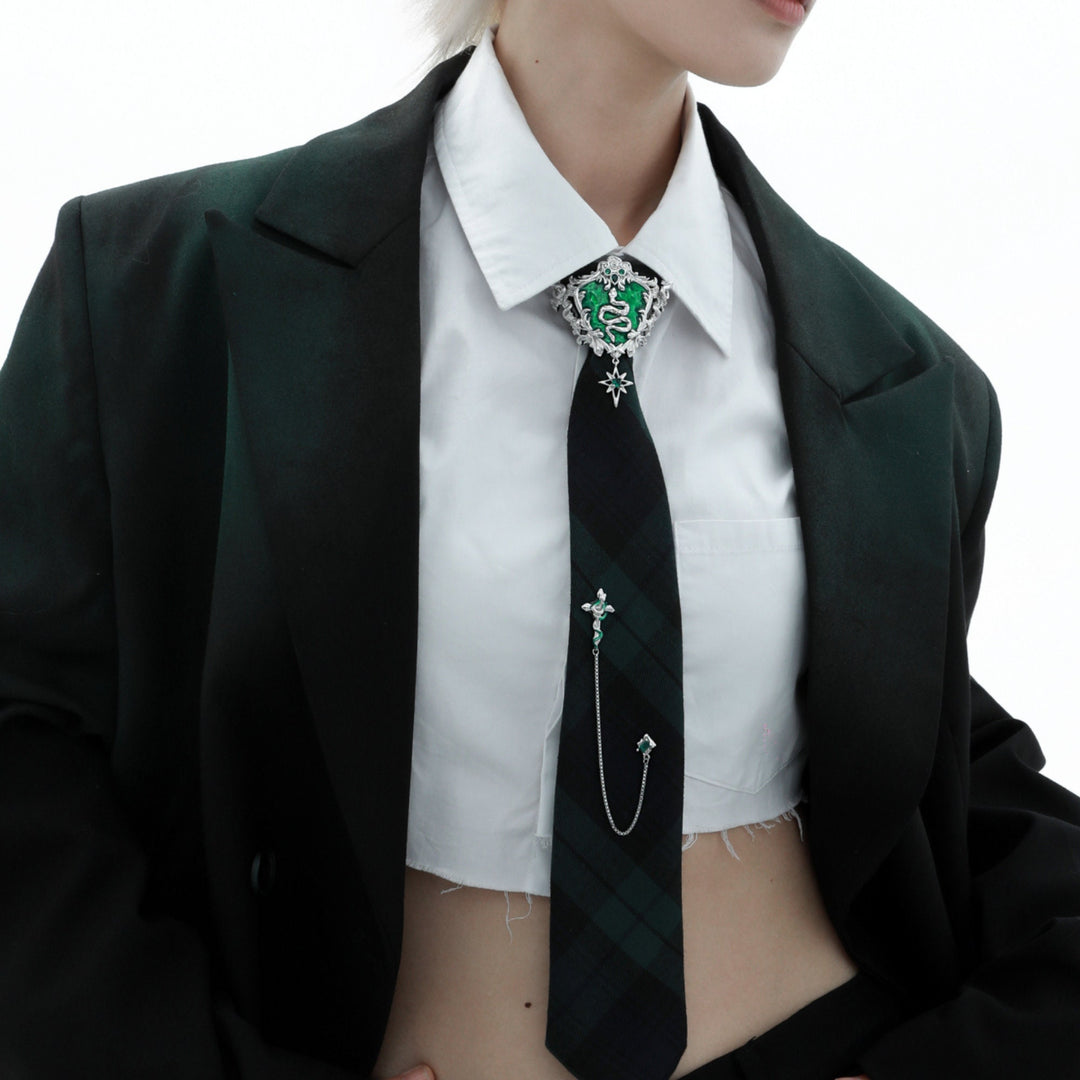 a woman wearing a suit and tie with a cross on it