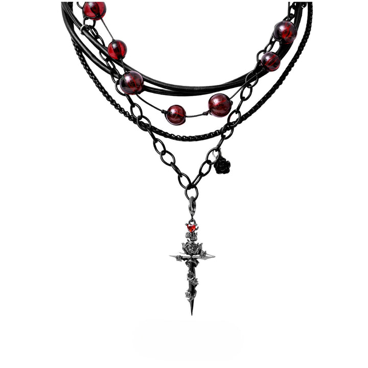 a necklace with a cross and beads on it